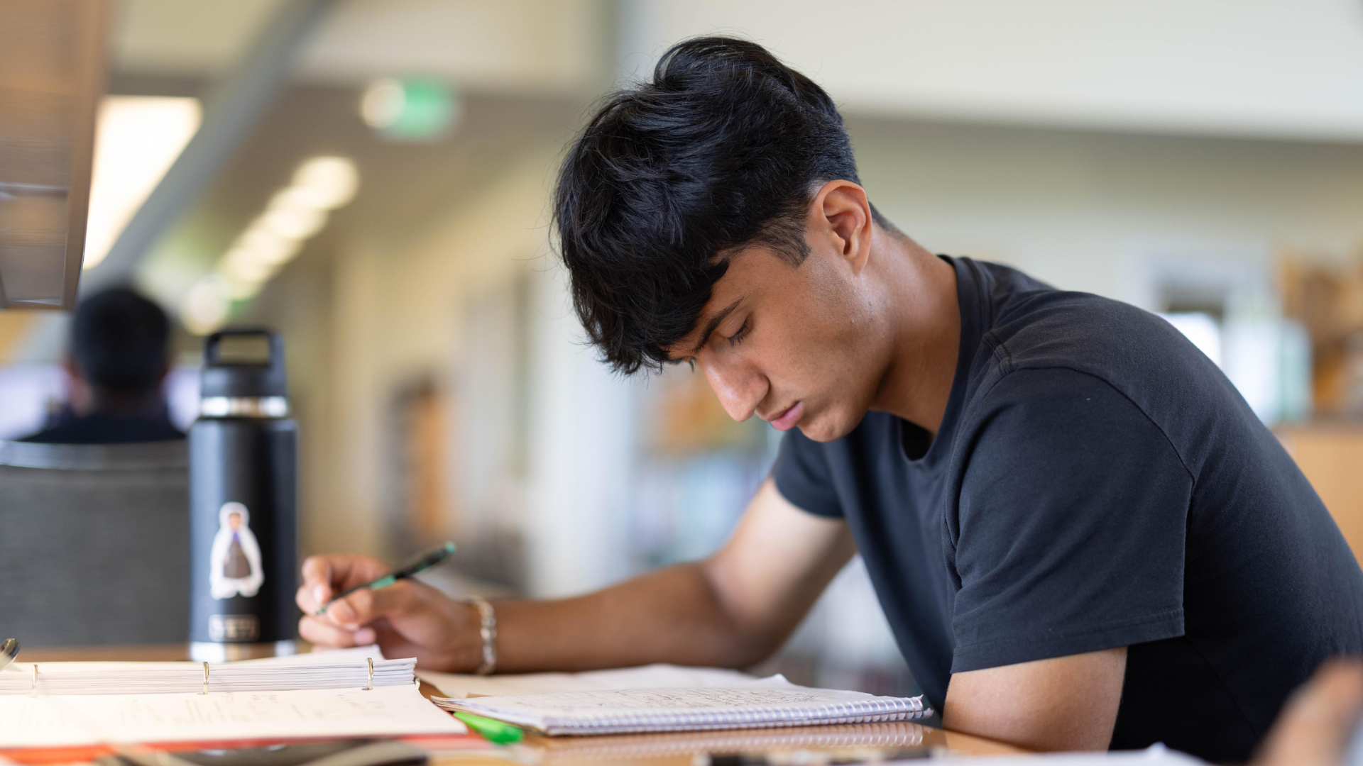 Male-presenting student studying in the Learning Center