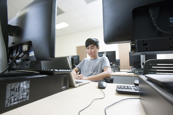 digital arts student boy working on computer