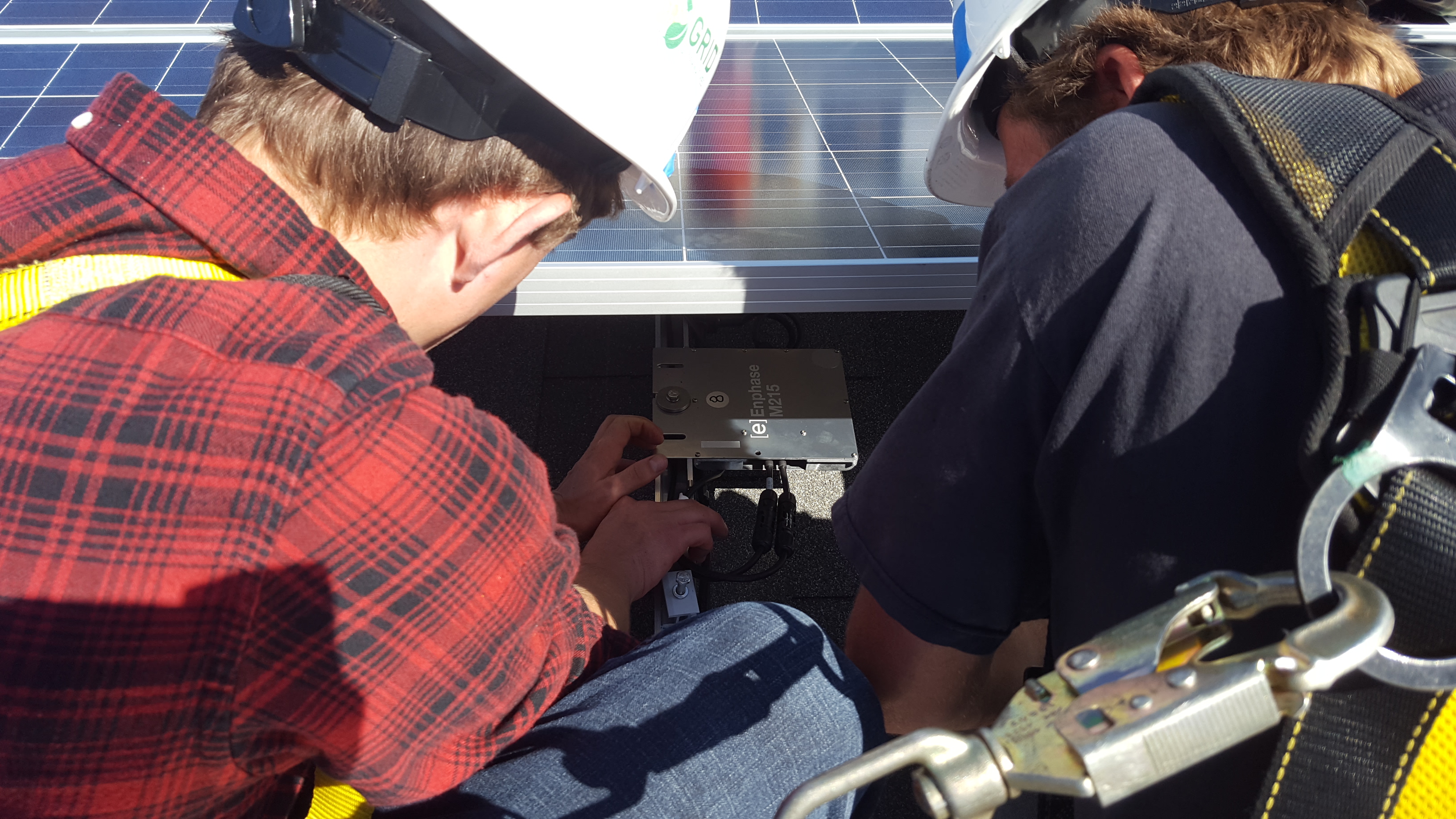 Students installing microinverters in PV installation